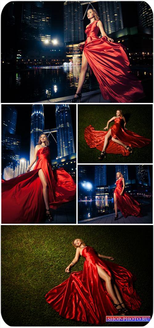 Девушка в красном платье на фоне ночного города / Girl in a red dress on a night city - Stock Photo